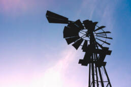 Photograph of a silhouette of a windmill against the sky